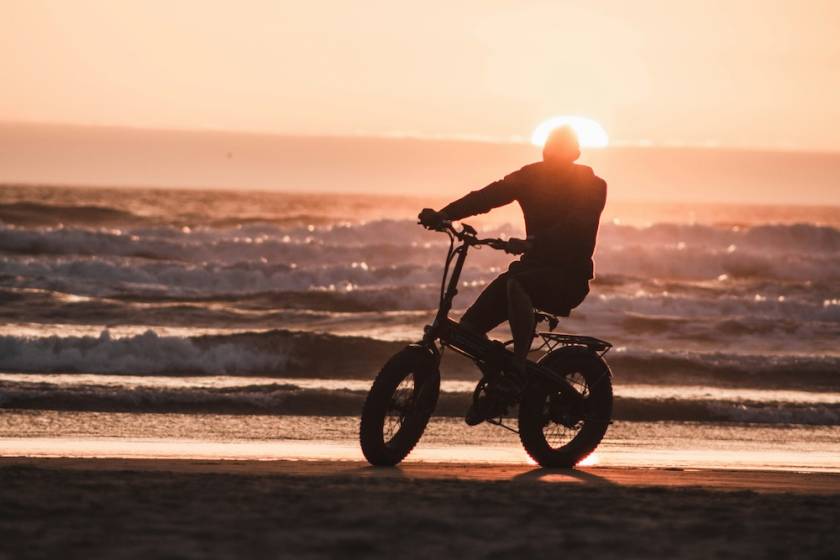 Man biking on the beach