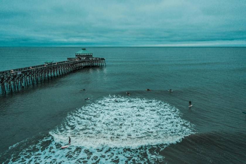 Surfers in the water near the Folly Beach Pier